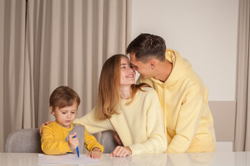 Cute family, parents with son painting
