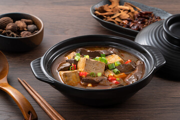 Spicy duck blood jelly soup and stinky tofu with scallion and chili pepper topping.