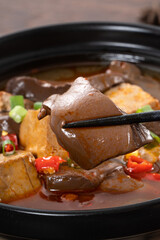 Spicy duck blood jelly soup and stinky tofu with scallion and chili pepper topping.