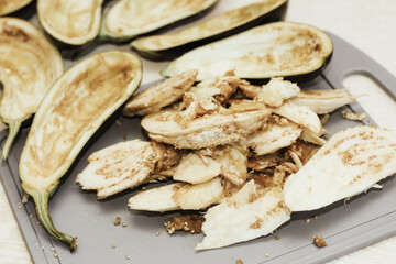 Eggplant cut without pulp on a white table before cooking.