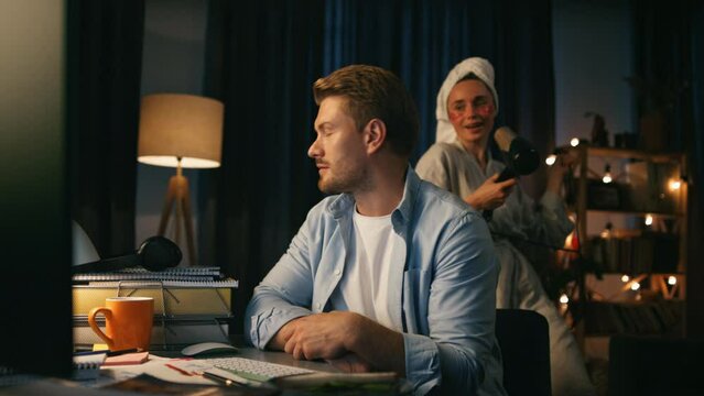 Videocalling man ignoring housewife at home closeup. Woman distracting boyfriend