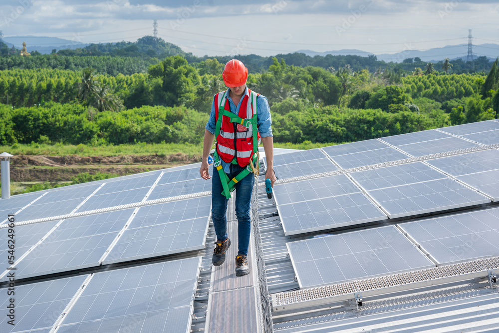 Poster engineer man or worker checking the operation of the system solar panels or solar cells on roof,rene
