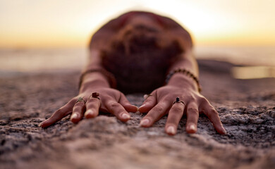 Yoga, pilates and beach hands with zen of a woman on ocean sand for chakra and wellness meditation....