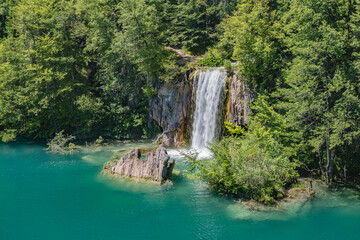Fototapeta na wymiar Beautiful view of waterfalls with crystal clear water in forest in The Plitvice Lakes National Park in Croatia Europe.