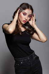 Beauty portrait of young woman. Brunette girl with evening female makeup and black T-shirt