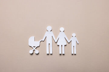 Paper family figures on beige background, top view. Insurance concept