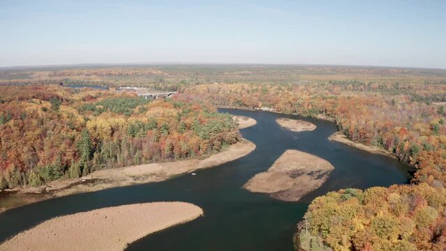 Au Sable River in Michigan during fall colors with drone video moving forward.
