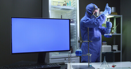 Scientist with protective suit and blue screen