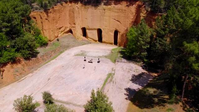 Circling aerial shot of a Dj setting up his set outside Bruoux Mines