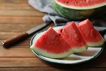 Sliced fresh juicy watermelon on wooden table, closeup