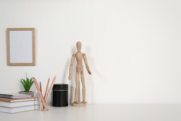 Comfortable workplace with white desk near wall at home