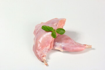 Two raw rabbit legs with bone on a white background