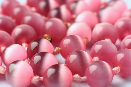 Shiny pink gemstone chrysoberyl background, cat's eye beads