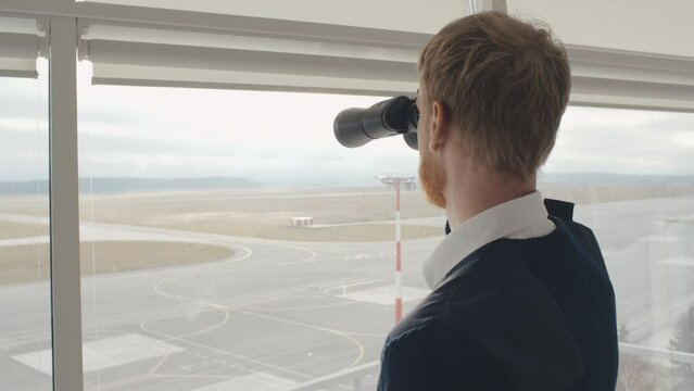 Navigational officer lookout on navigation looking through binoculars. Realtime