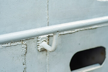 Close-up of a steel railing beam welded to a metal hull.