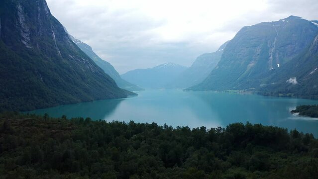 Lake bottom Loenvatnet with glacial river starting to flow dowm Lodalen valley Forward moving aerial