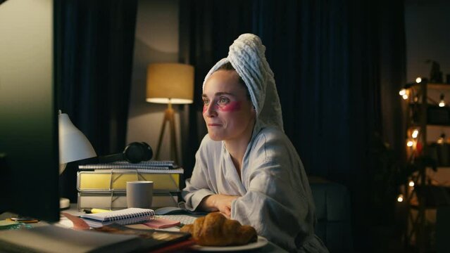 Closeup freelancer working computer late at night. Smart bathrobe woman smiling