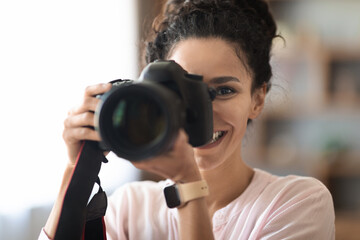 photo of Female photographer with DSLR at home or studio - obrazy, fototapety, plakaty
