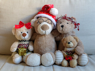 Christmas teddy bear family (parents and two children) portrait on a sofa