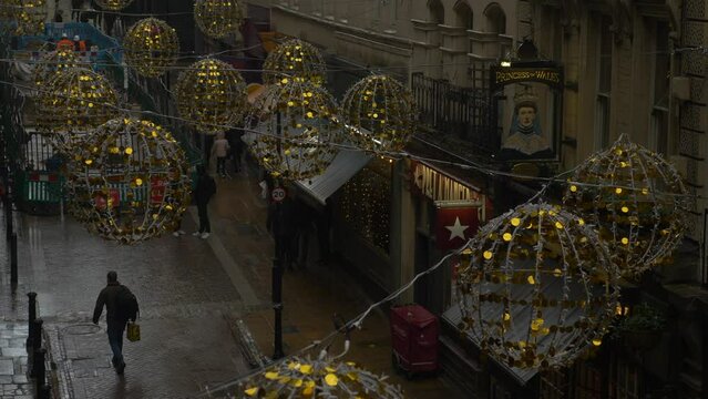 Christmas Lights Off on Shopping Street Wet Dark Day