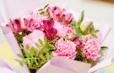 a bouquet of pink peonies and carnations