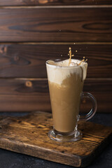 coffee latte in a glass on wooden board