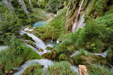 Majestic view of waterfall with crystal clear water in forest in The Plitvice Lakes National Park...