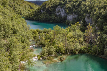 Fototapeta na wymiar Top view of Plitvice Lakes with waterfalls with crystal clear water in surrounding forest in The Plitvice Lakes National Park in Croatia Europe.