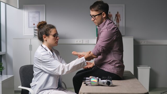 doctor check amputated limb and adjust hand prosthesis to patient