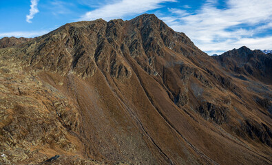 Peak and ridge of high rocky mountains with cliffs.
