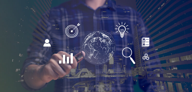 Businessman holding a magnifying glass, technology, global internet connection application for business and digital marketing. Finance and Banking digital link technology big data city background