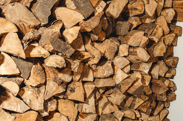 stack of neatly stacked firewood is dried under a canopy in the open air. Background for design. Cover.
