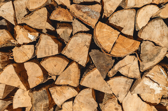 Finely chopped and stacked firewood. Stacks of Firewood. Preparation of firewood for the winter. Firewood background.