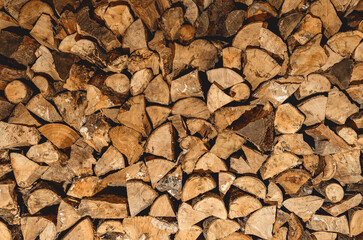 Finely chopped and stacked firewood. Stacks of Firewood. Preparation of firewood for the winter. Firewood background.