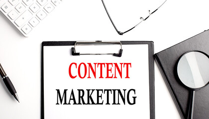 CONTENT MARKETING text written on paper clipboard with office tools