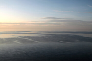 Fototapeta na wymiar View on the blue sky flowing into the blue sea, backgraund