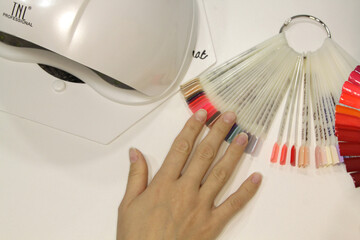 
Workplace of a manicure master. A salon specialist performs work with a client.
Nail technician...