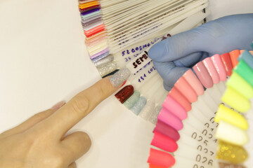 
Workplace of a manicure master. A salon specialist performs work with a client.
Nail technician...