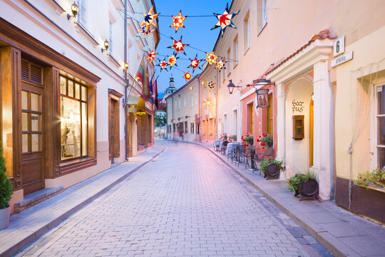Night view of illuminated Stikliai Street in Jewish quarter of the Old Town of Vilnius, Lithuania.