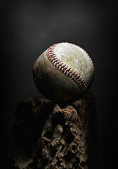 Used baseball ball close-up on a rough wooden platform. Fine art