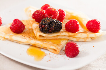 pancakes with raspberries, blackberries and honey
