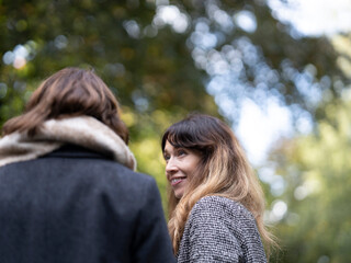 Fototapeta premium Women looking at each other in park