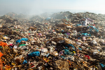 Closeup of burning trash piles in landfill