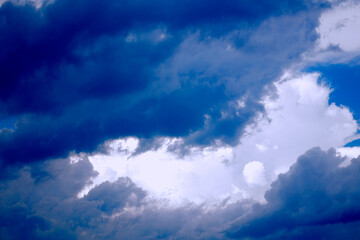 Naklejka na ściany i meble Blurred background. Blue sky and white fluffy clouds.