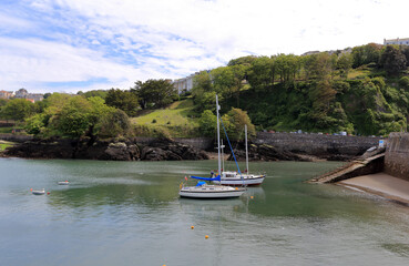 Fototapeta na wymiar View of a small bay, with two sailing boats at Ilfracombe.