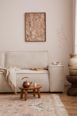 Warm and cozy living room with mock up poster frame, modern beige sofa, wooden oval coffee table,...