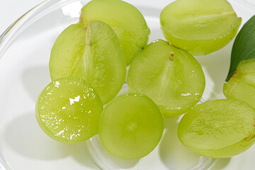 Cut Shine Muscat grapes on a white background.