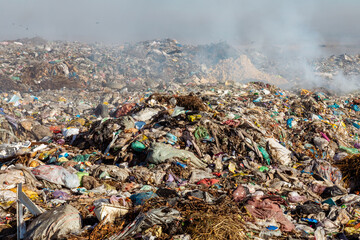 Closeup of burning trash piles in landfill