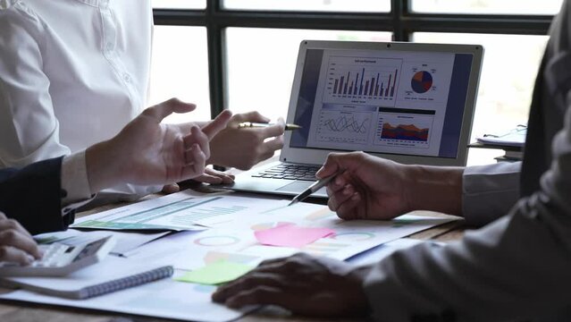 Asian business adviser meeting to analyze and discuss the situation on the financial report in the meeting room.Investment Consultant,Financial Consultant,Financial advisor and accounting concept