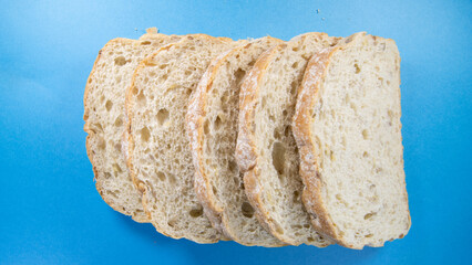 five slices of fresh seeded bread isolated on a dark blue background